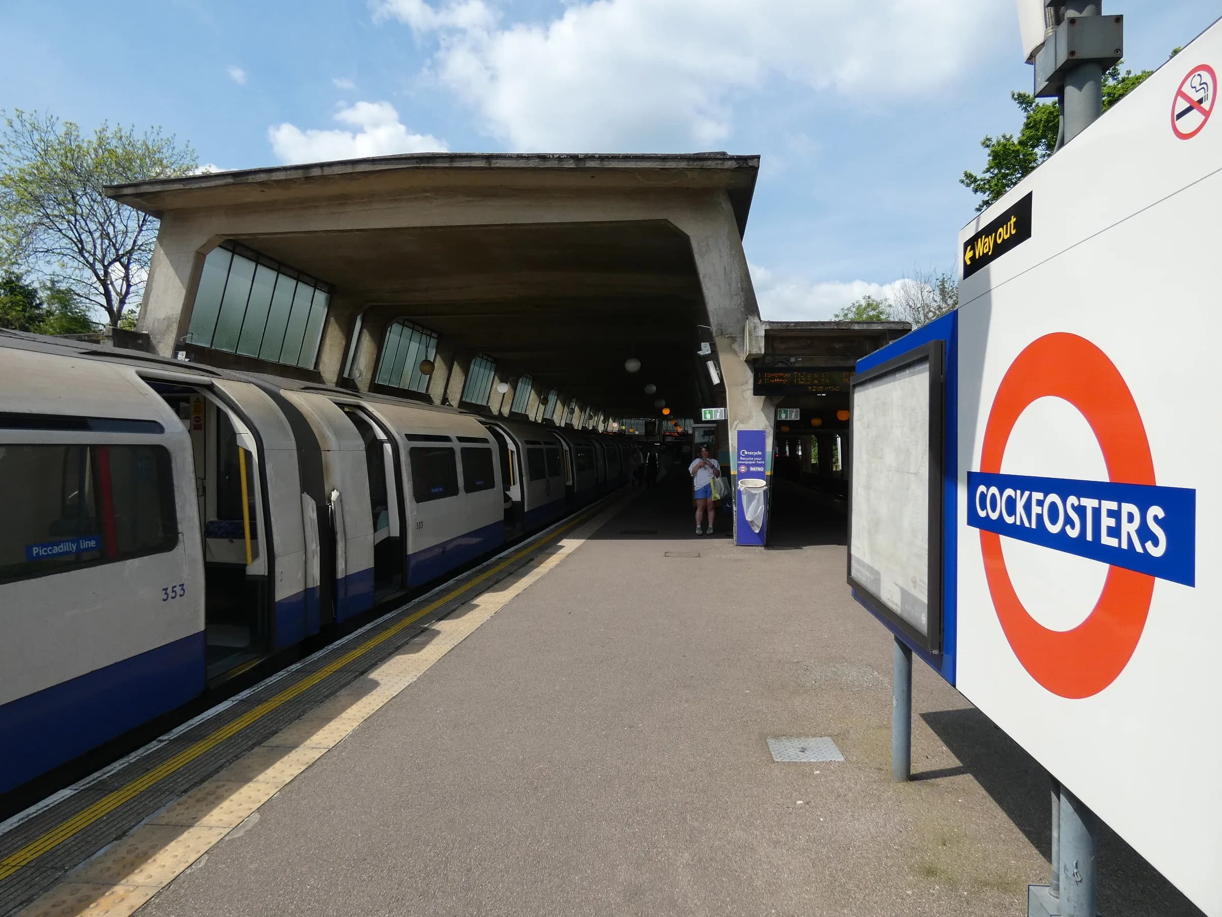 A Piccadilly line train under the platform canopy at Cockfosters station