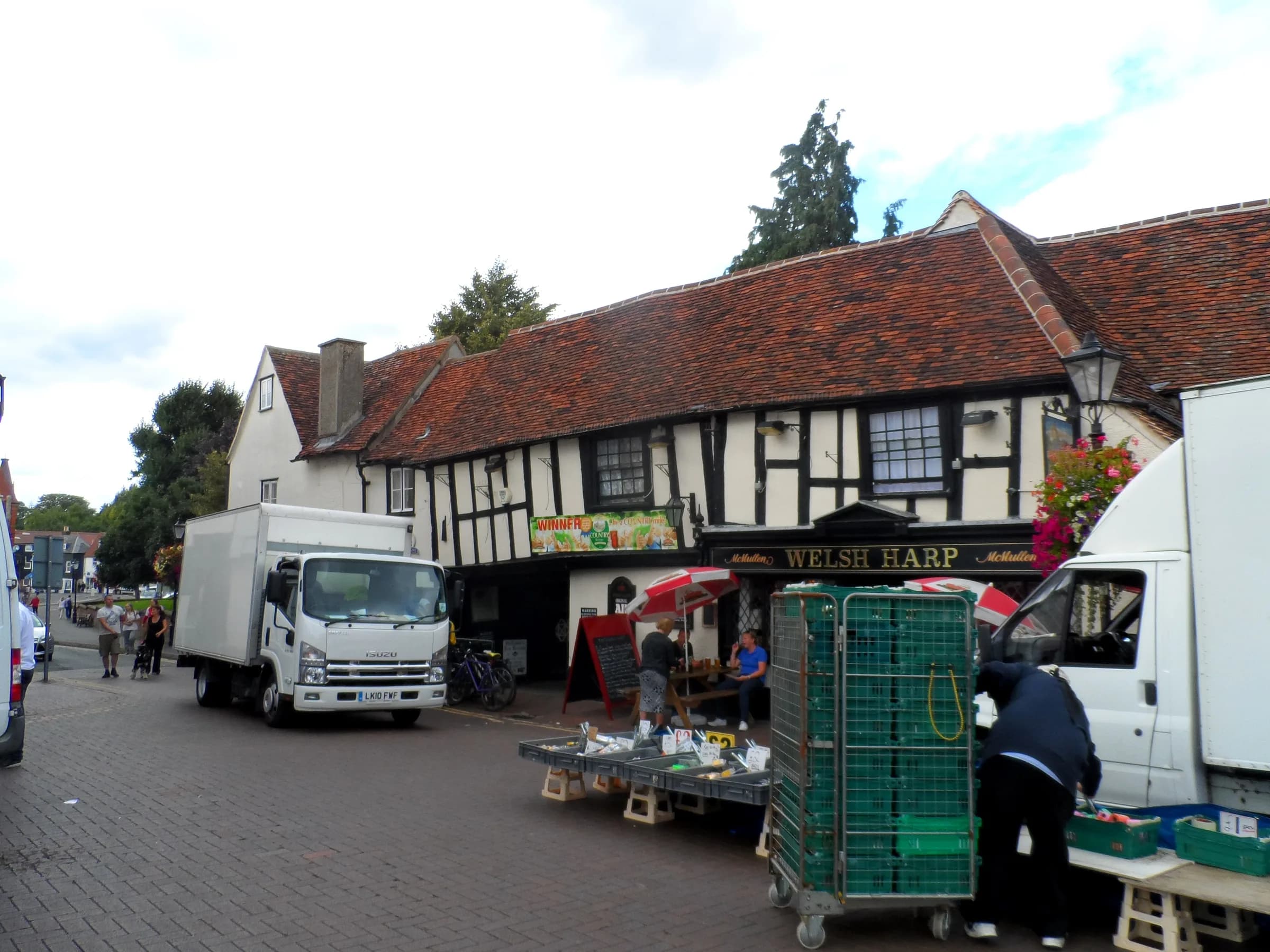 A timber-framed pub and market stalls in Waltham Cross town centre