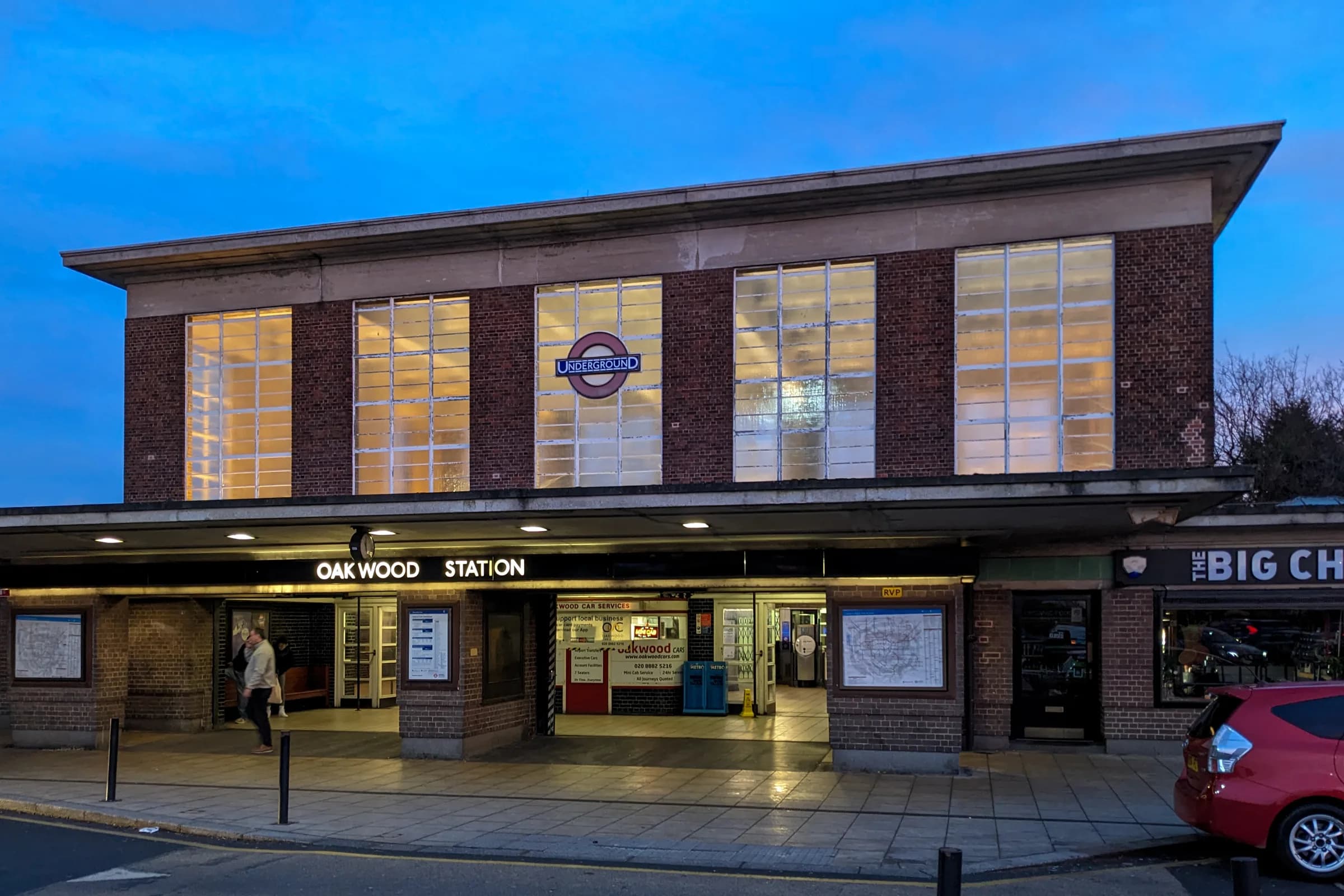 The brick entrance building of Oakwood Underground station at dusk