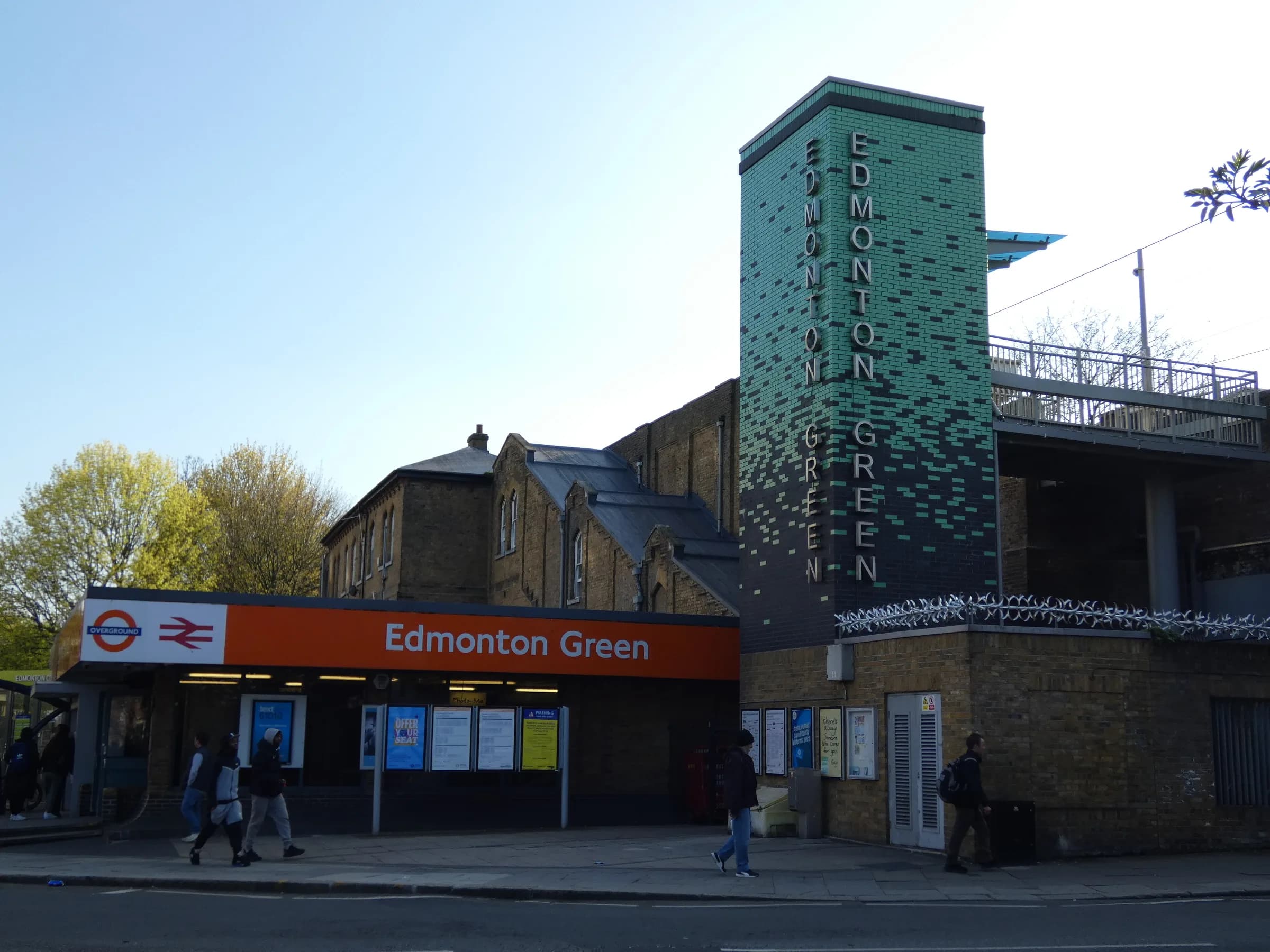 Edmonton Green station with its tall green tower and orange station sign